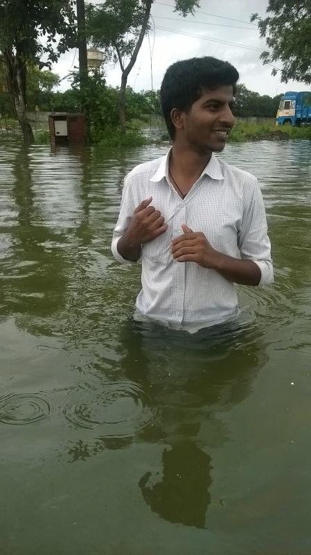 Our-associate-wading-through-water-near-the-office-449x800